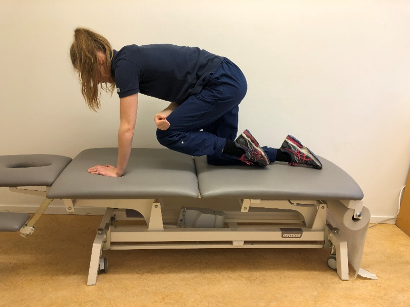 Tjej p&aring; brits st&aring;endes p&aring; alla fyra. H&ouml;gerhanden p&aring; v&auml;nster kn&auml;. V&auml;nstra kn&auml;t lyft fram&aring;t mot &ouml;verkroppen 